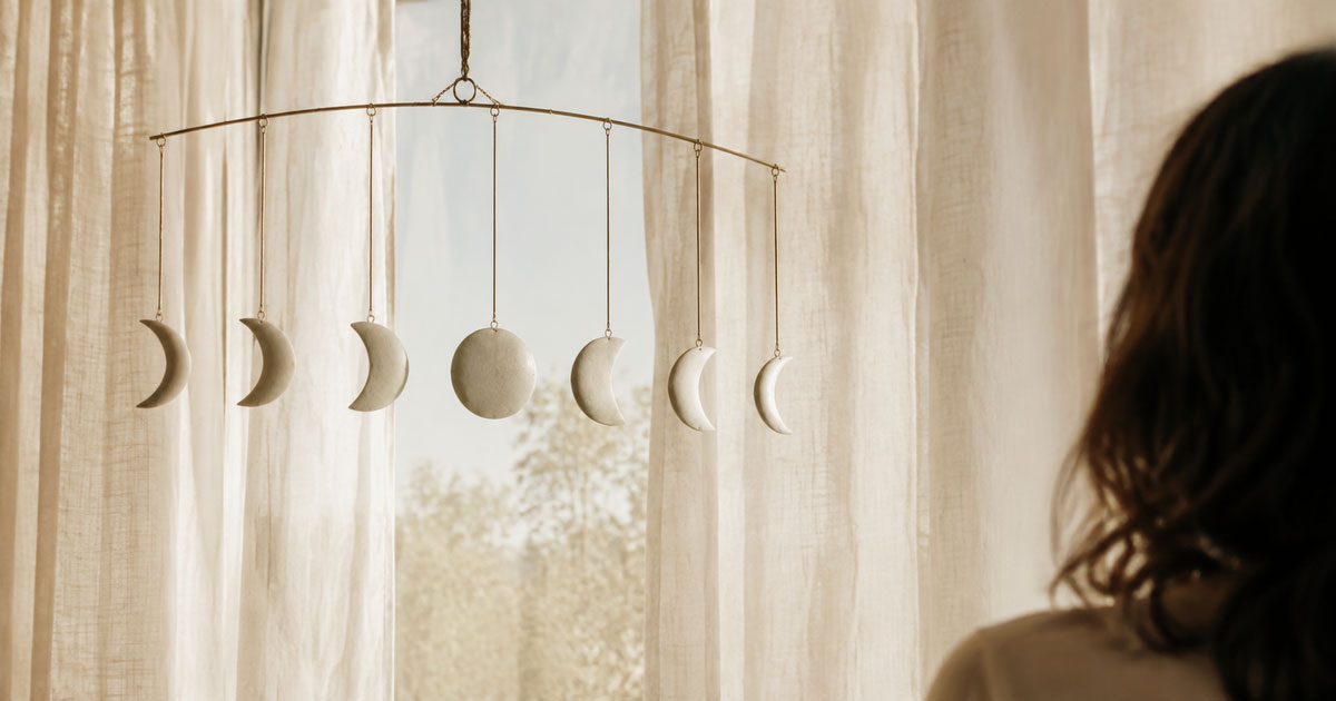 A crescent moon shown mid-cycle, half in shadow, half lit